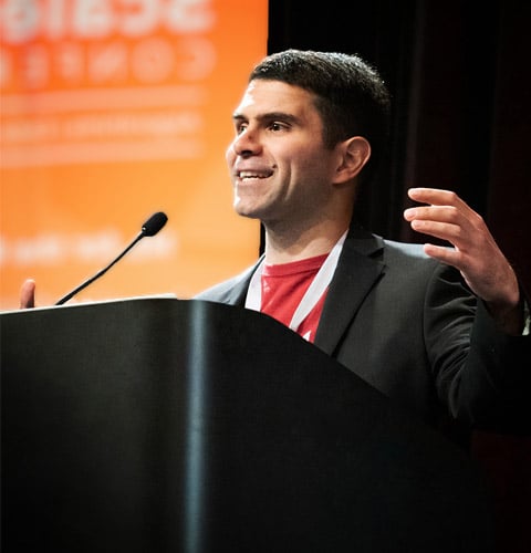 Reza Zadeh speaking at a podium